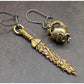 Pendientes Inefables espada serpiente manzana bronce detalles
